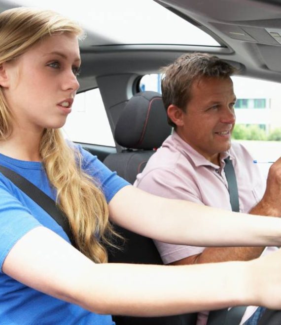 Teenage Girl Taking A Driving Lesson