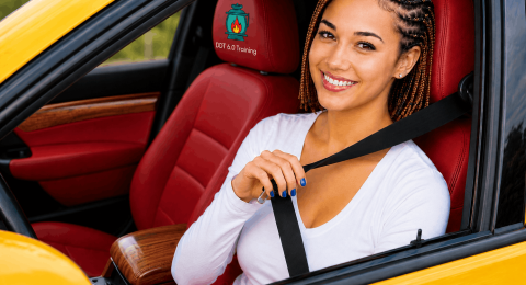 Woman wearing a seat belt while driving a car for road safety