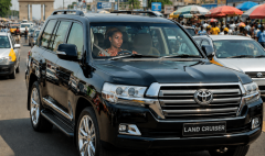 Toyota Land Cruiser driving on a busy road in Ghana representing defensive driving and road safety awareness training